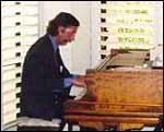 Photo of John Adams at the piano